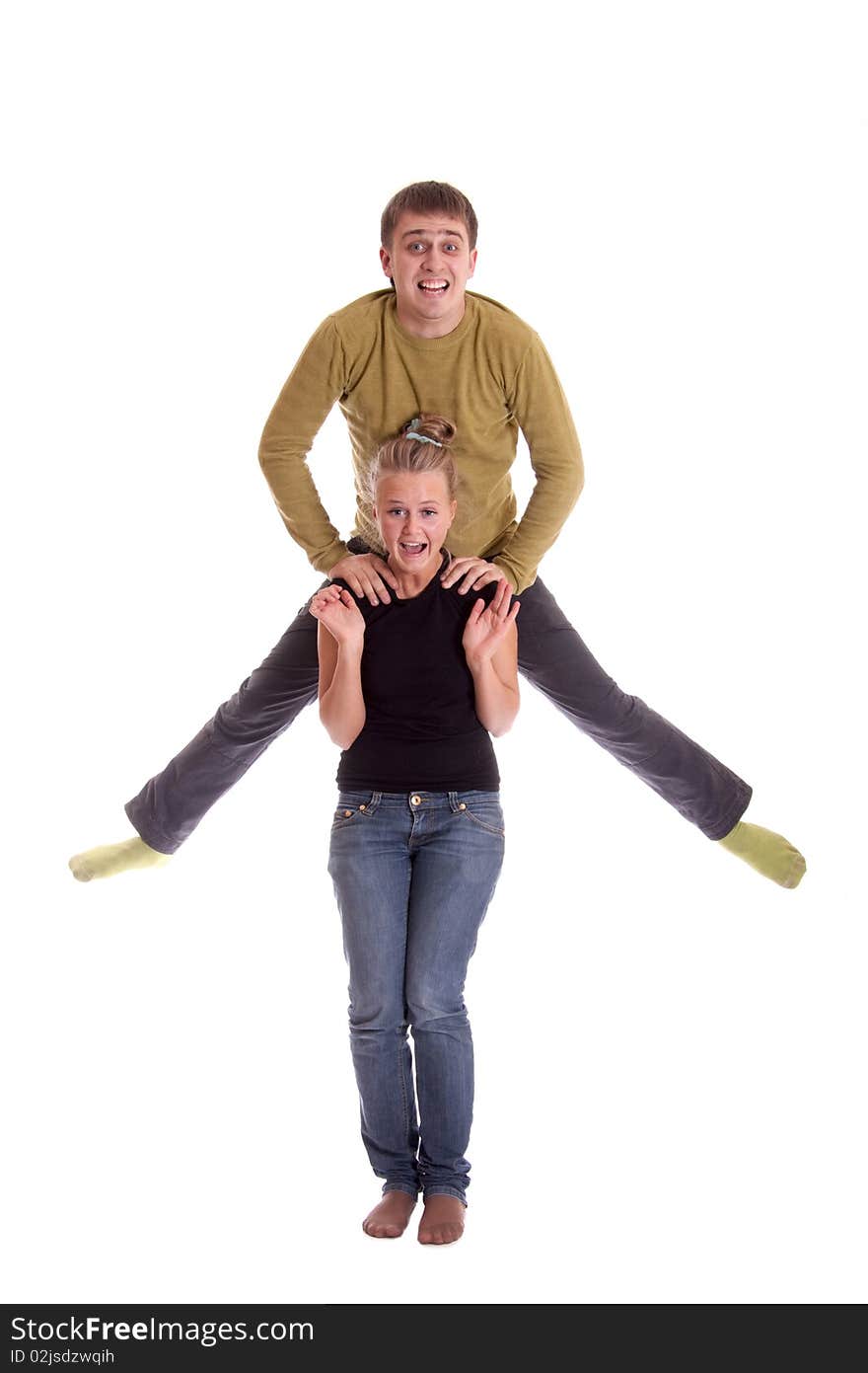 Boy jump in air, his girlfriend smiling, shot in studio on white background