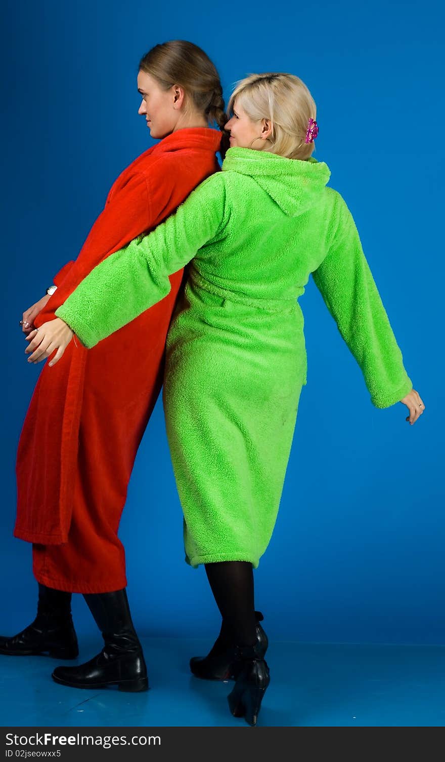 Two happy friends girl in bathrobes