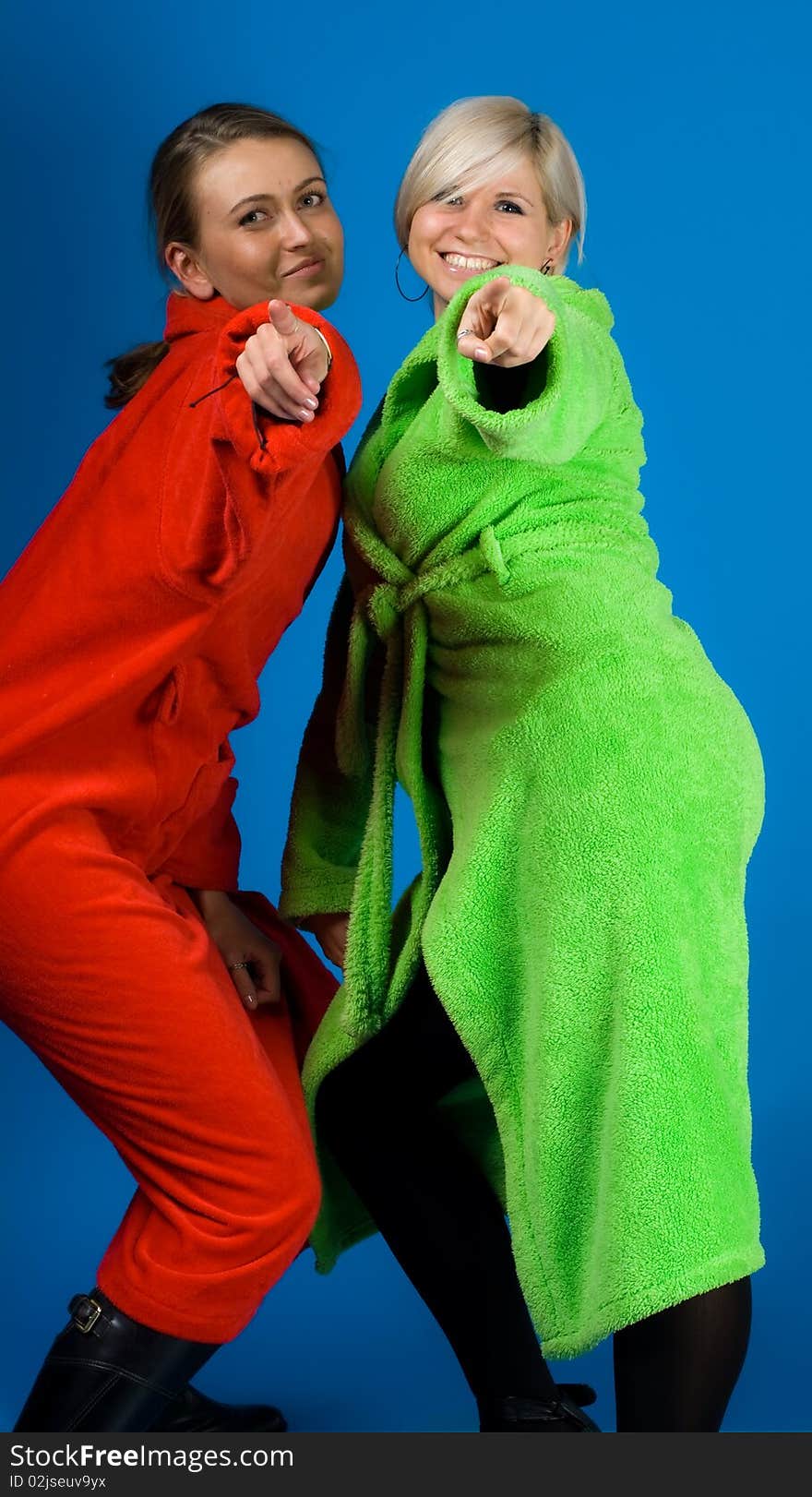 Two beautiful smiling friends girls in the bathrobes. Two beautiful smiling friends girls in the bathrobes