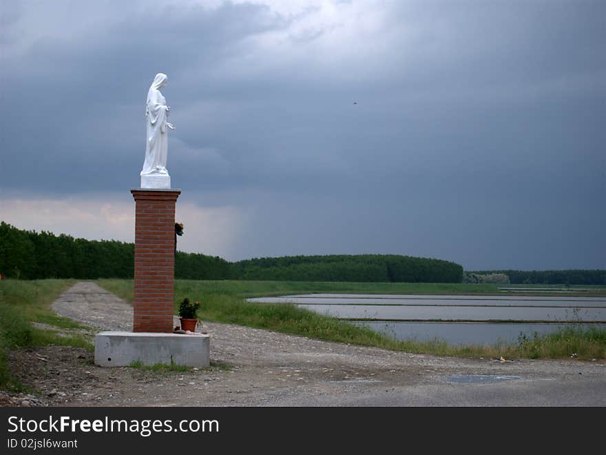 Madonna's statue looking at italian country. Madonna's statue looking at italian country