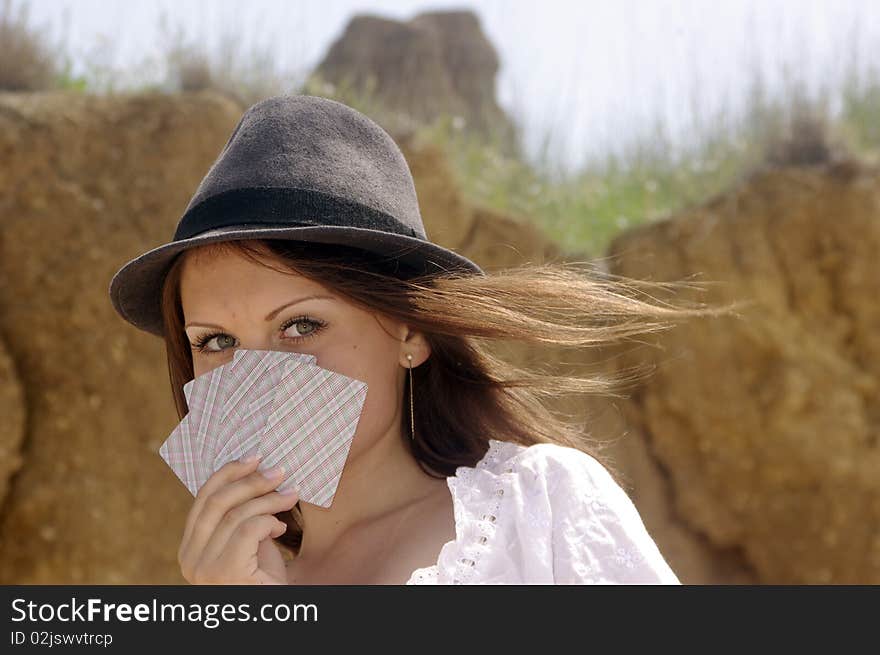 Lady in a country hat with cards. Lady in a country hat with cards