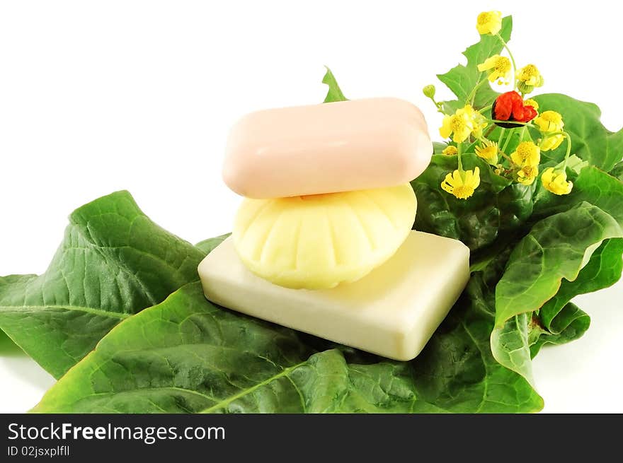 Soap on a stack of sheets of grass isolated on white background