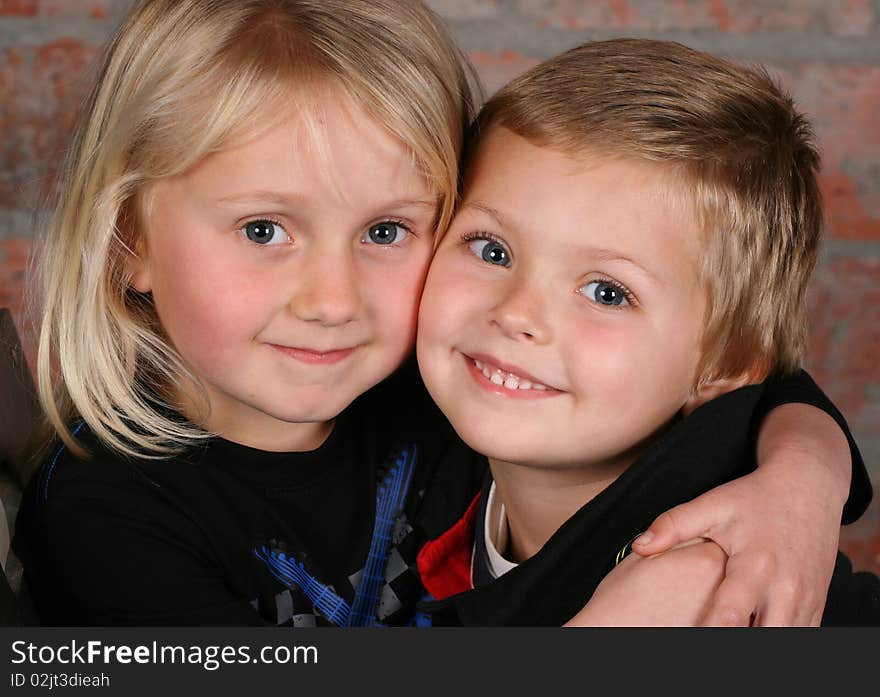 Beautiful young girl with blond hair and her cute boy friend. Beautiful young girl with blond hair and her cute boy friend