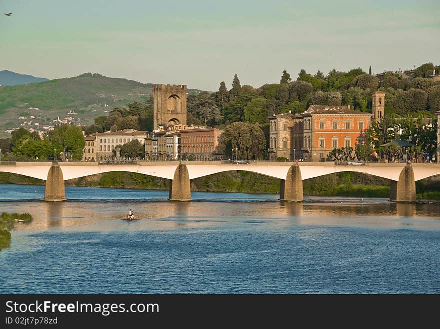 A bridge crossing over the Arno River, just behind the Ponte Vecchio bridge in Florence, Italy.