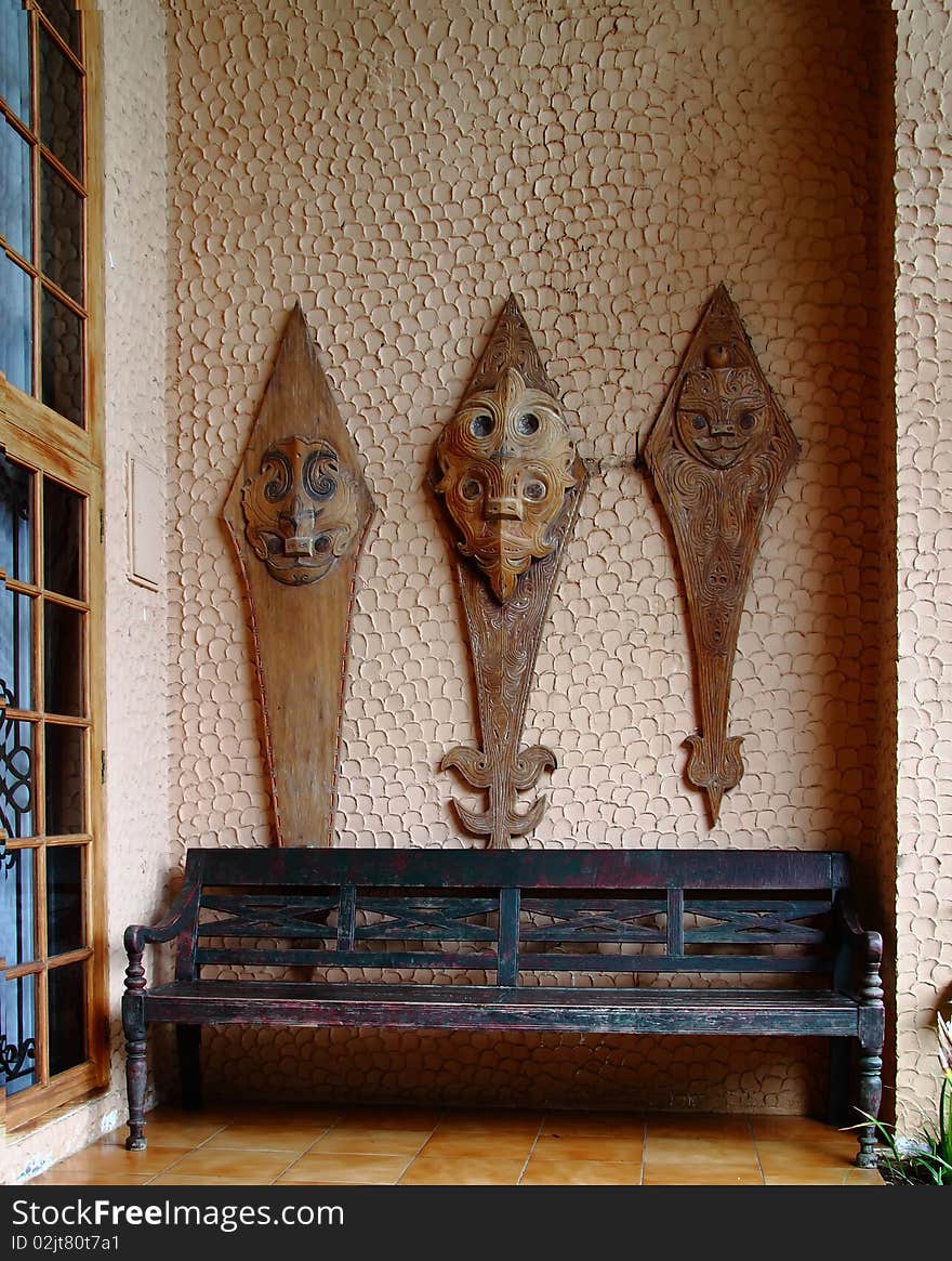 Terrace with traditional wood carving from Papua in the villa, Indonesia