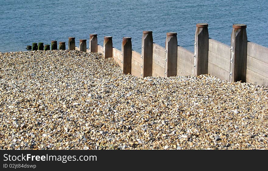 Photo of breakwater pebble beach and sea. Photo of breakwater pebble beach and sea.