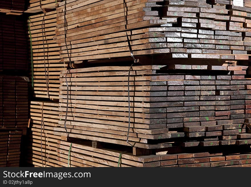 Tacks of a hardwood in lumber warehouse ready for transportation. Tacks of a hardwood in lumber warehouse ready for transportation.