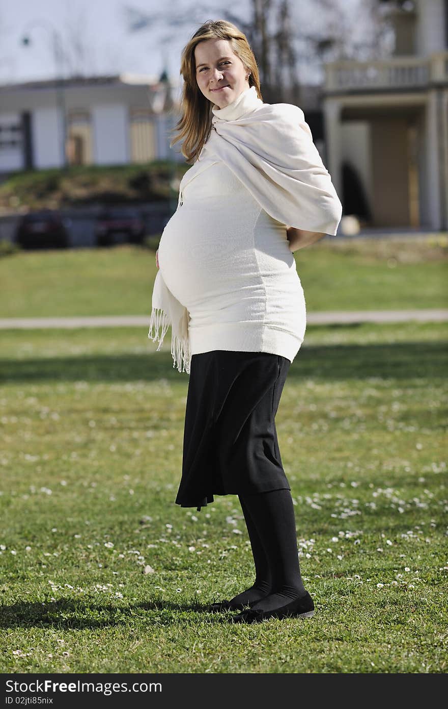 Happy young pregnant woman outdoor