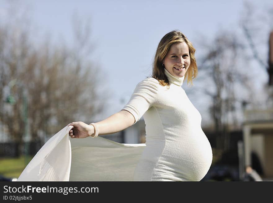 Happy young pregnant woman outdoor