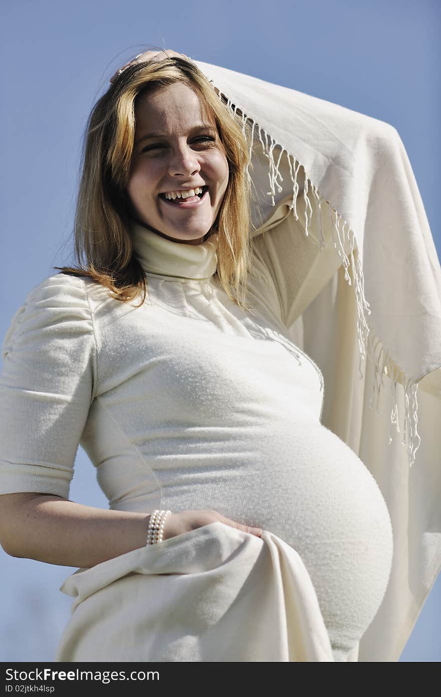 Happy young pregnant woman outdoor