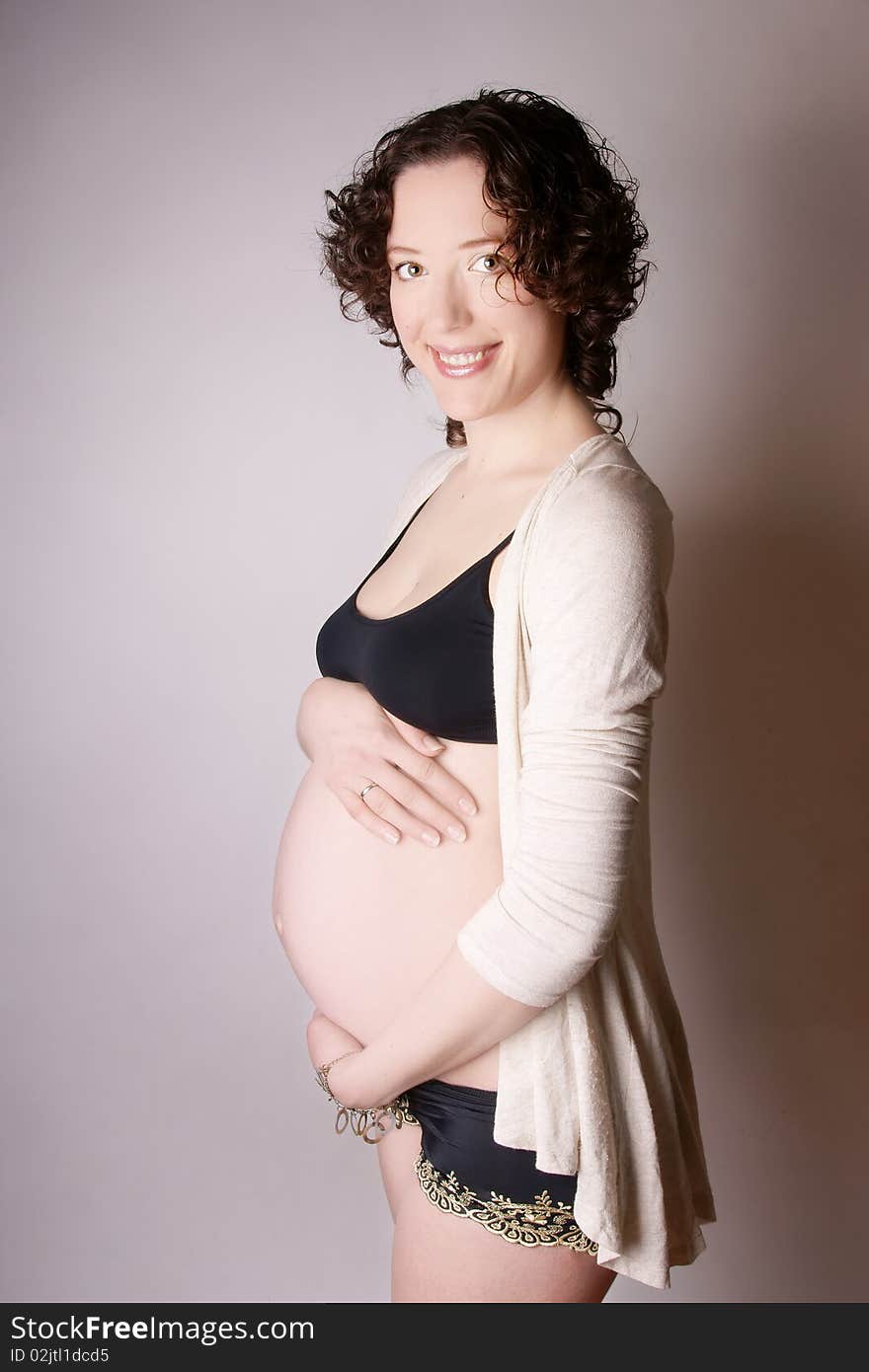 Young beautiful happy smiling pregnant woman, studio shot