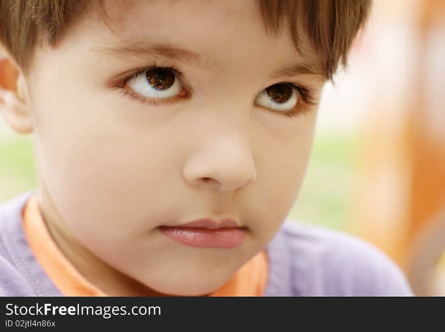 Portrait of cute little sad offended boy, outdoor shot. Portrait of cute little sad offended boy, outdoor shot