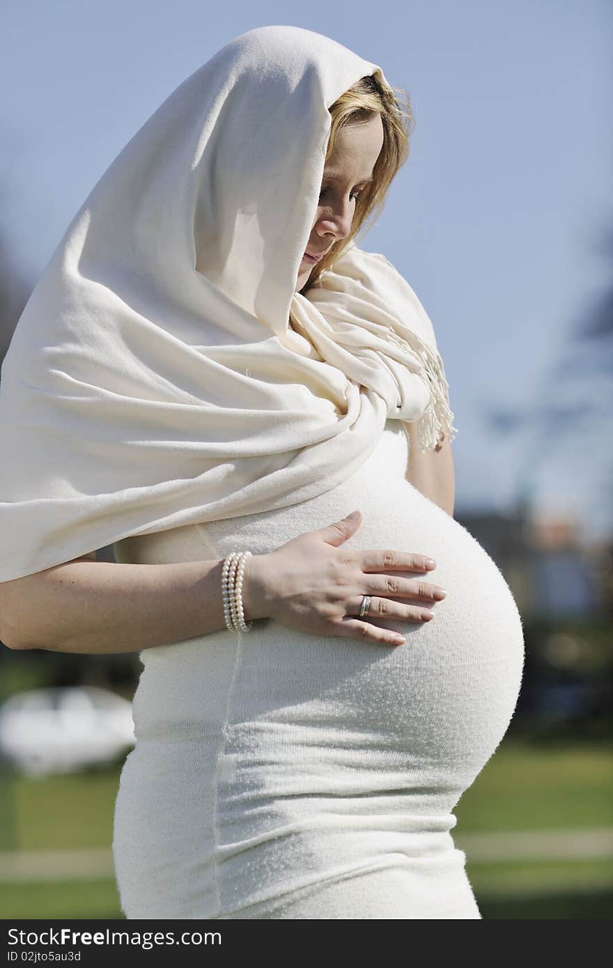 Happy young pregnant woman outdoor