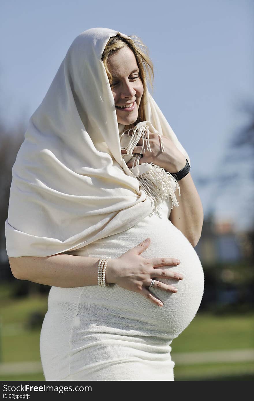 Happy young pregnant woman outdoor