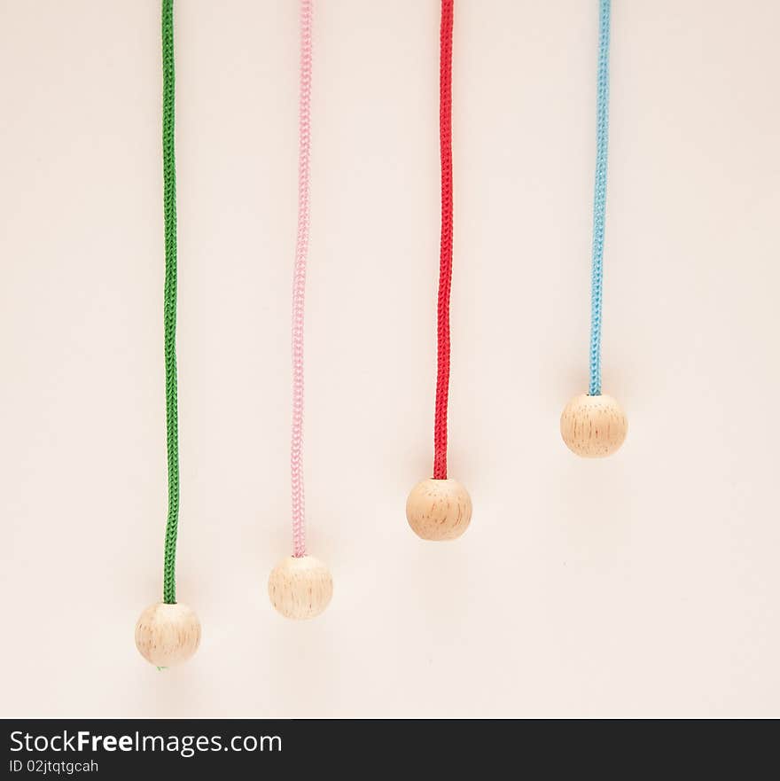 Hanging colour laces with wooden round tips