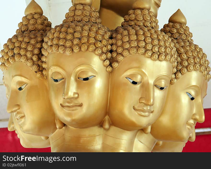 Multiple faces of gold buddha in the temple. Multiple faces of gold buddha in the temple