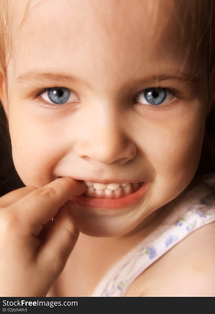 Beautiful little girl happily smiling closeup