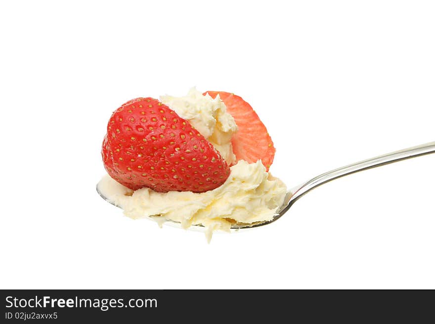 Strawberry and clotted cream in a spoon against white