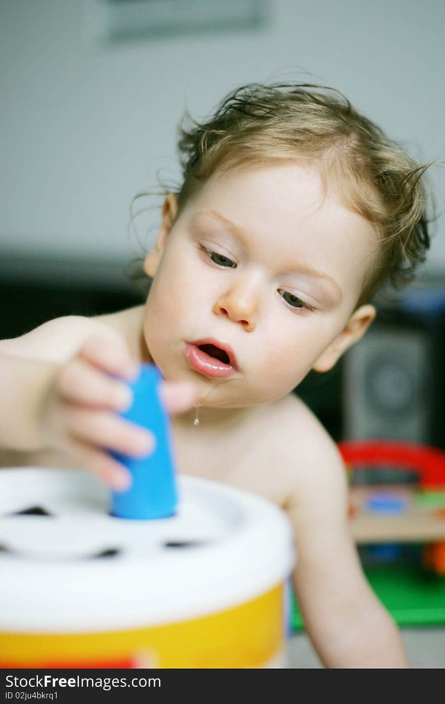 Teething baby concentraiting on play education toy. Teething baby concentraiting on play education toy