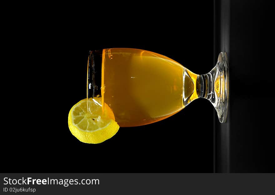 Orange juice glass on black