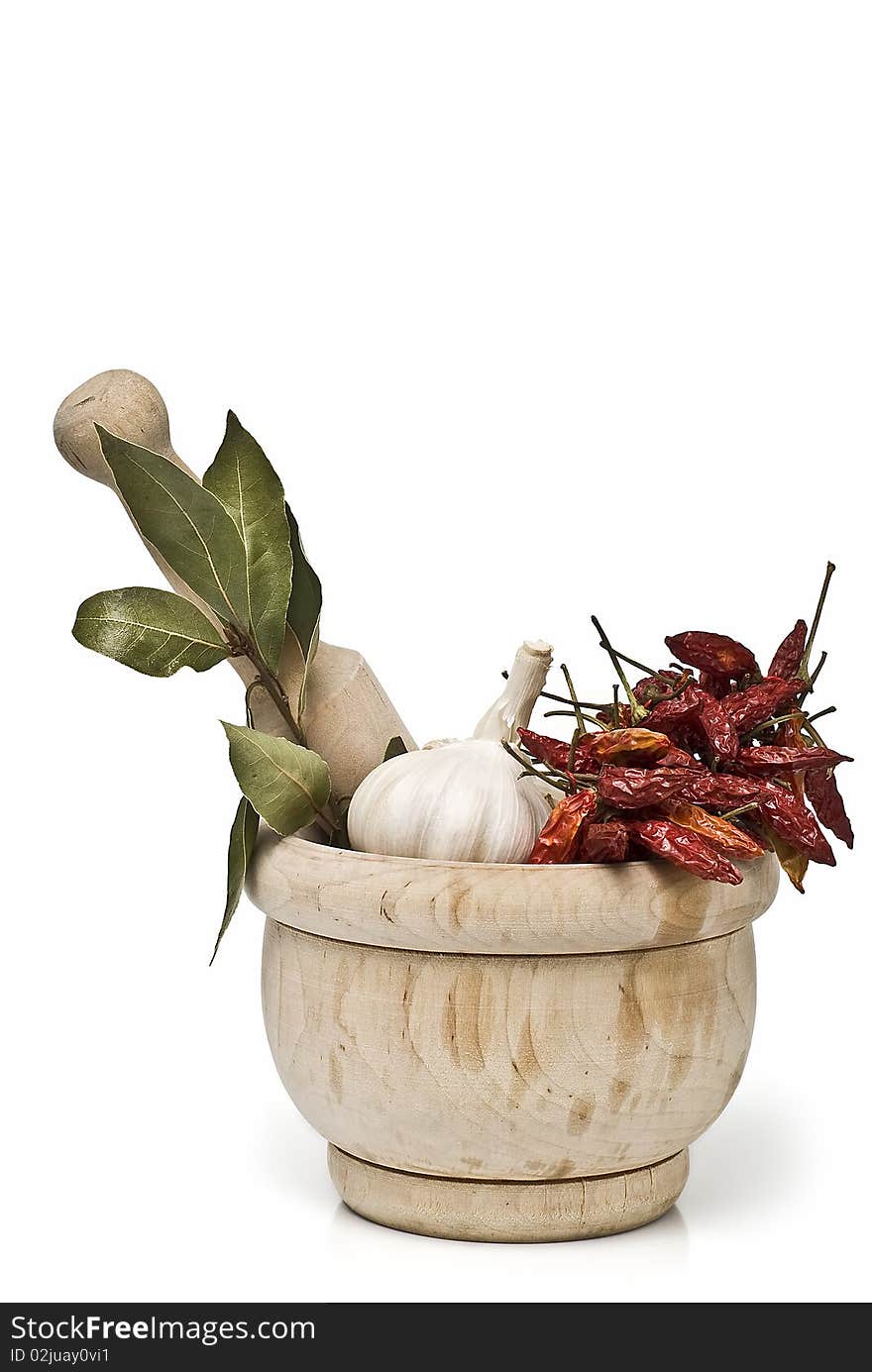 Spices in a mortar grinder isolated on a white background. Spices in a mortar grinder isolated on a white background.