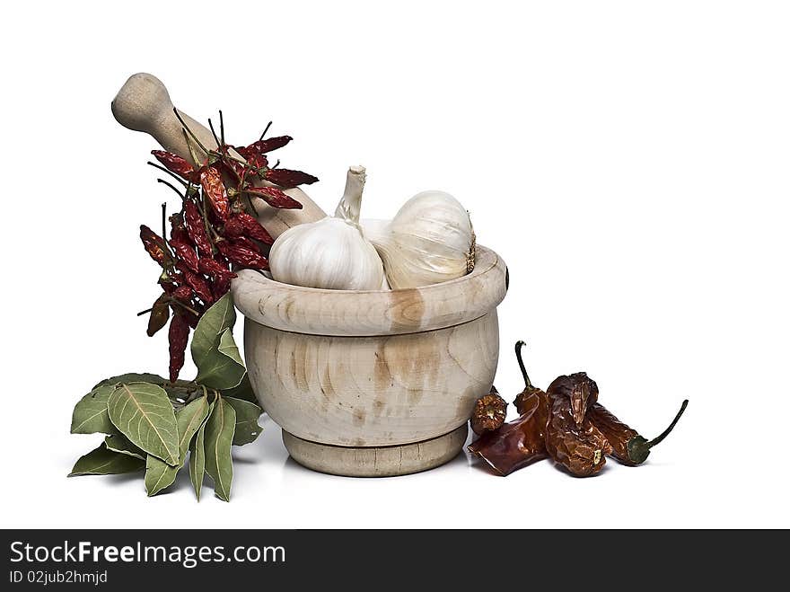 Some spices and a mortar grinder isolated on a white background. Some spices and a mortar grinder isolated on a white background.