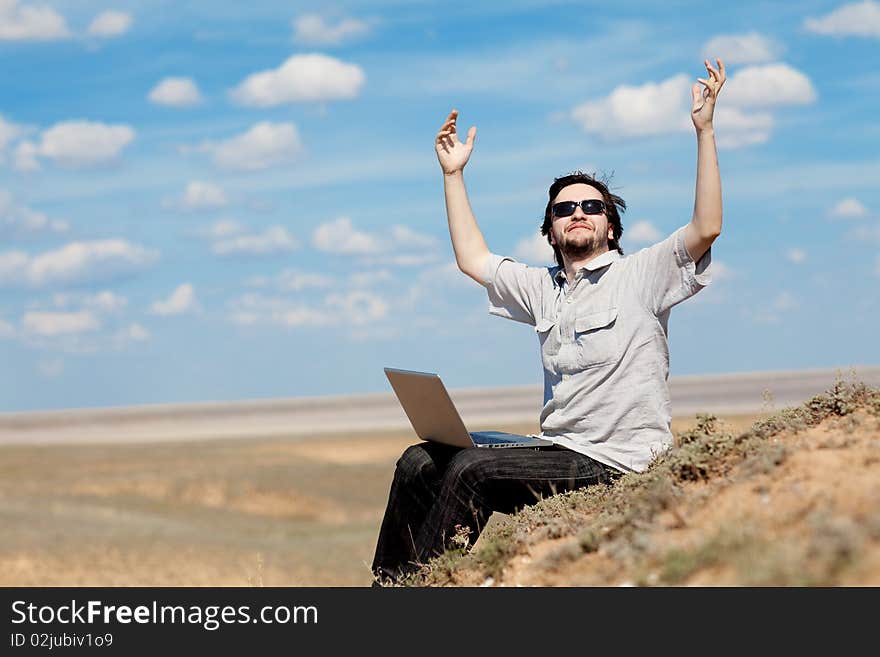 Man with laptop outdoors