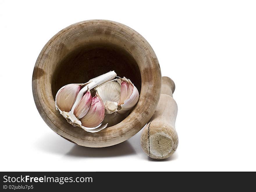 Garlic, mortar and pestle isolated on a white background. Garlic, mortar and pestle isolated on a white background.