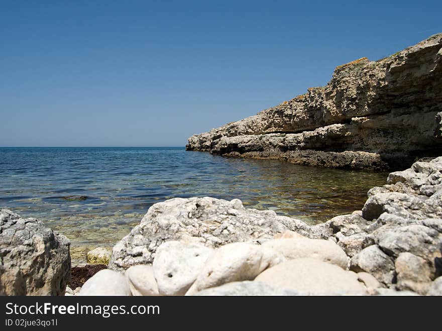 View on a quiet lagoon with rocky cliffs around the bay