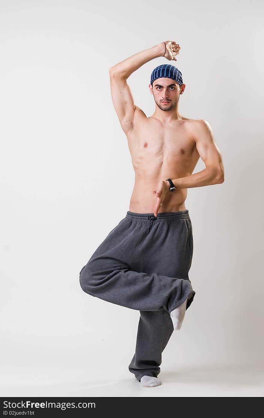 Handsome young dancer concentrated, studio shot