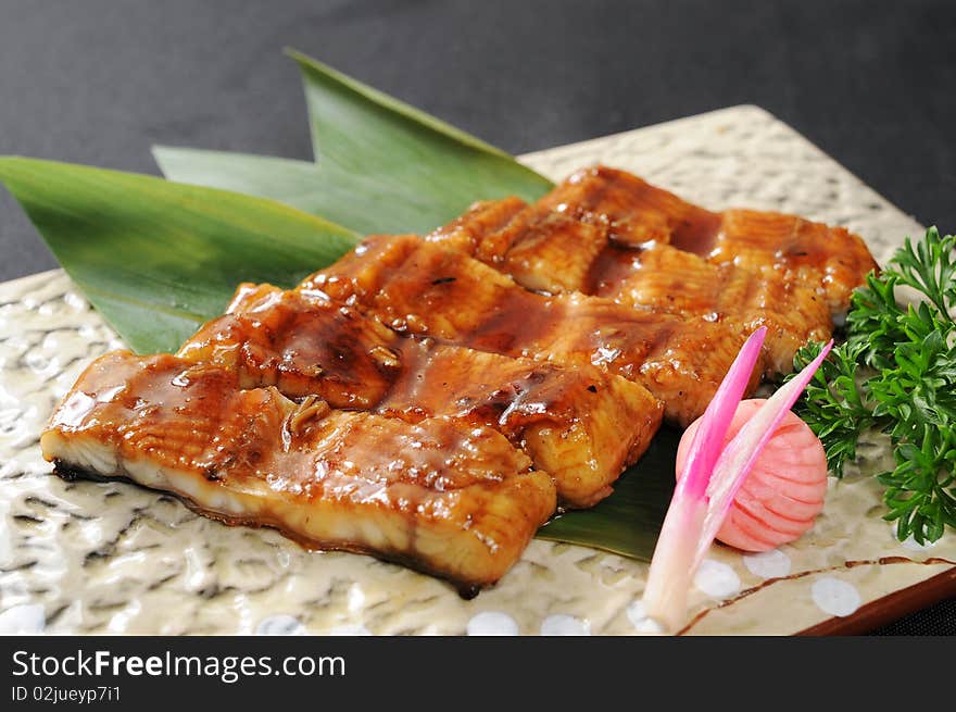 A fish restaurant row on white dish. A fish restaurant row on white dish