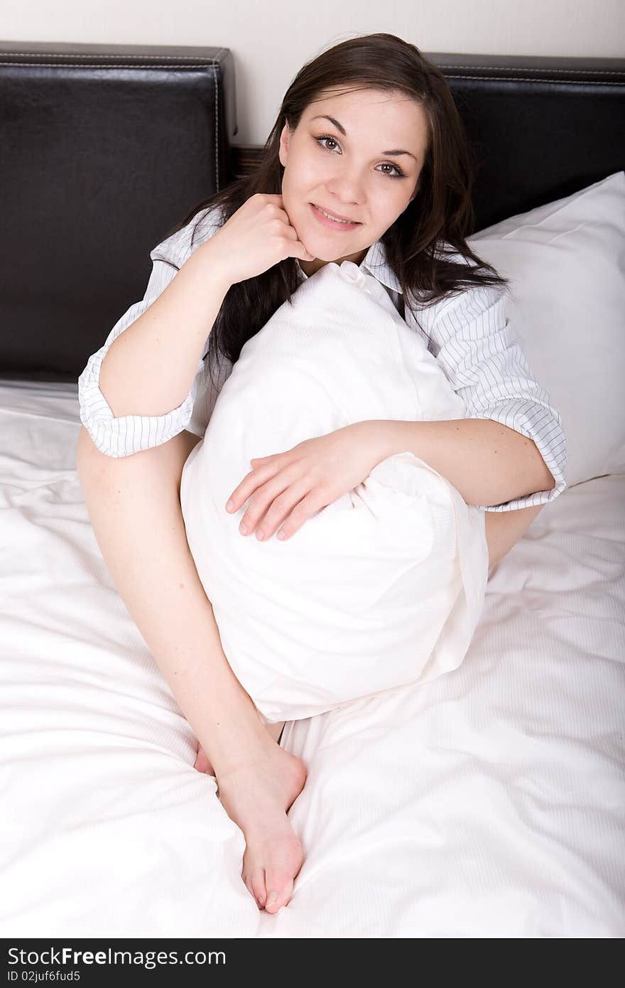 Young adult woman relaxing in bed. Young adult woman relaxing in bed