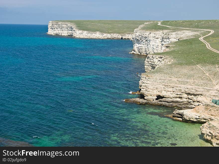 Sun shines over the bay with rocks and clear water. Western Crimea. Sun shines over the bay with rocks and clear water. Western Crimea