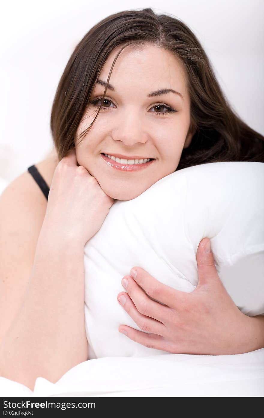 Young adult woman relaxing in bed. Young adult woman relaxing in bed