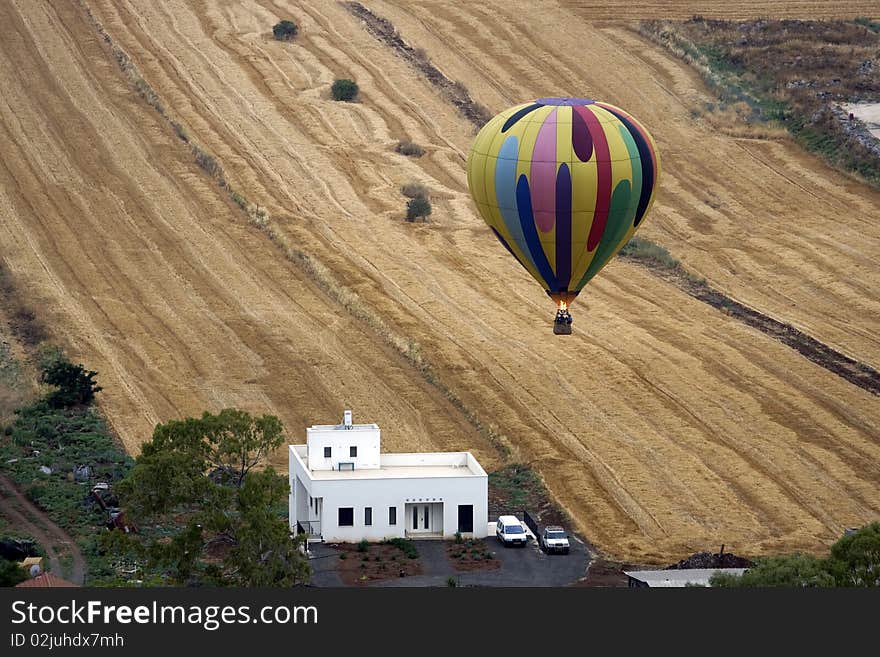 A hot air balloon above fields landscape