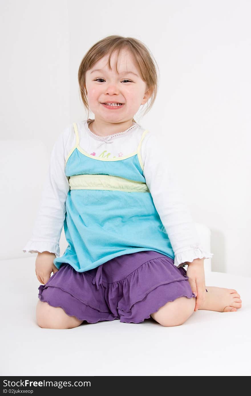 Happy little girl on sofa