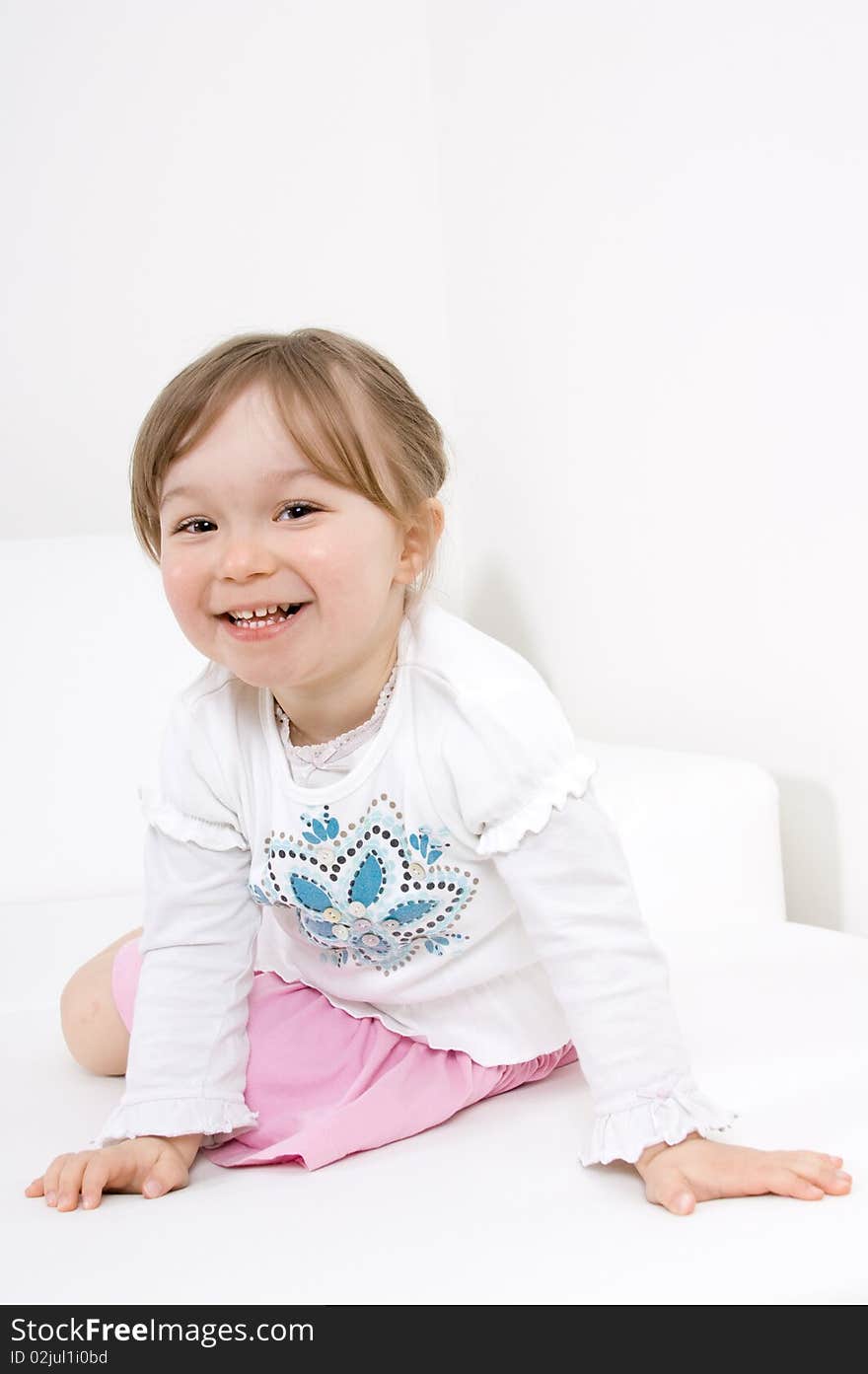 Happy little girl on sofa