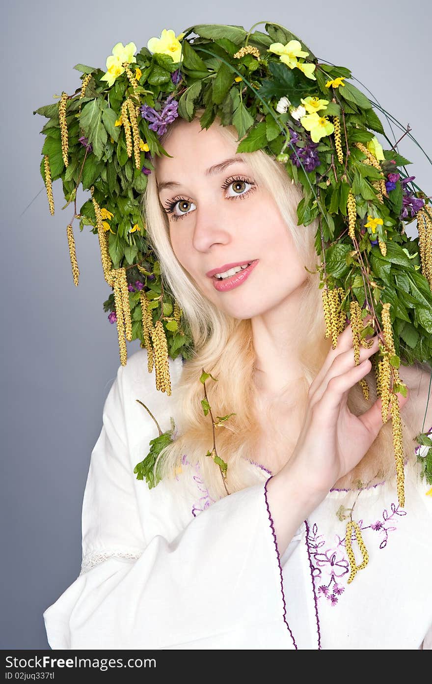 Portrait of a beautiful blonde girl in folk costume and chaplet. Portrait of a beautiful blonde girl in folk costume and chaplet