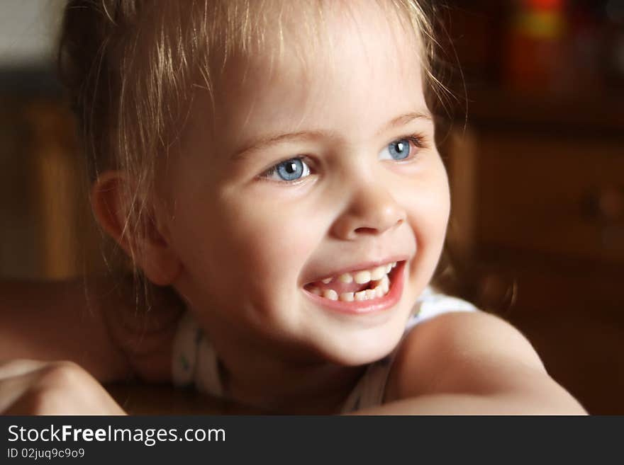 Beautiful little girl happily smiling closeup. Beautiful little girl happily smiling closeup