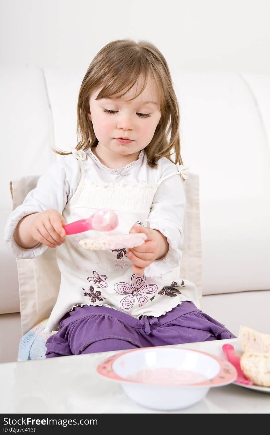 Sweet happy little girl eating