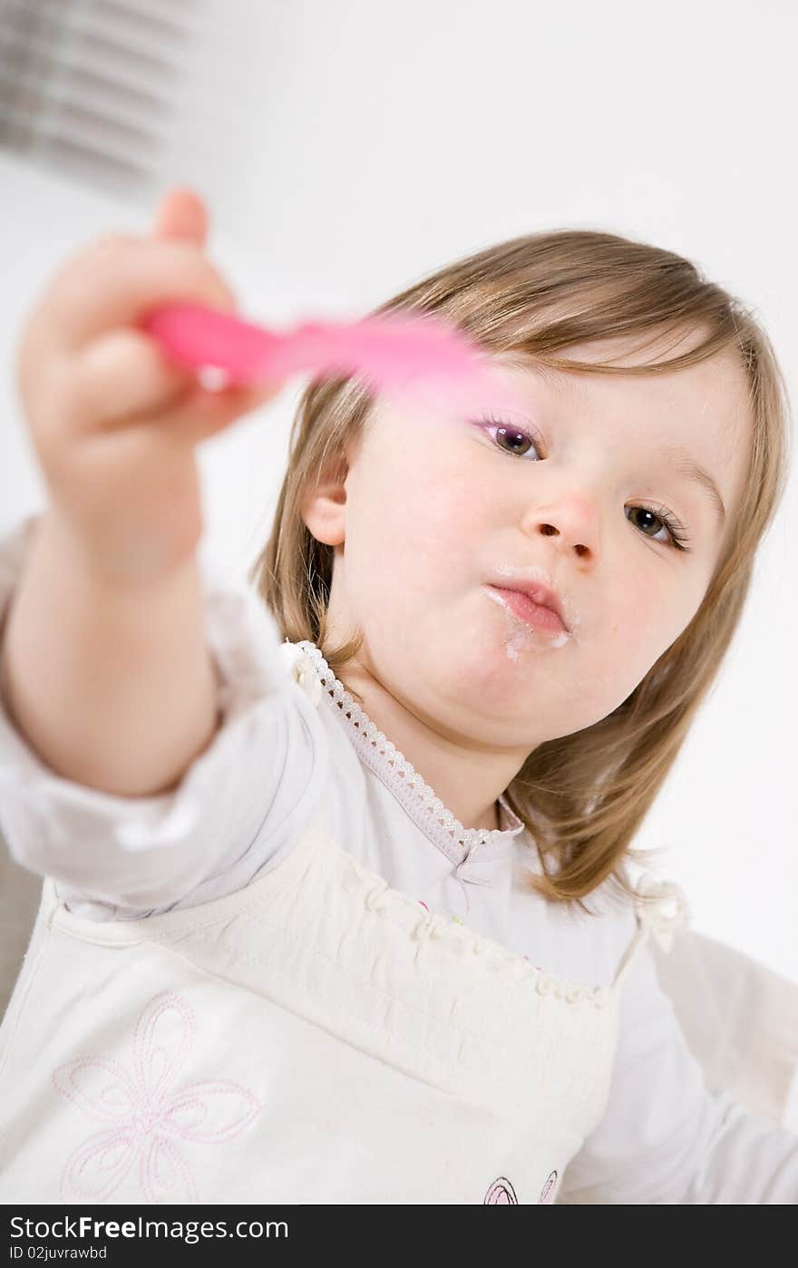 Sweet happy little girl eating