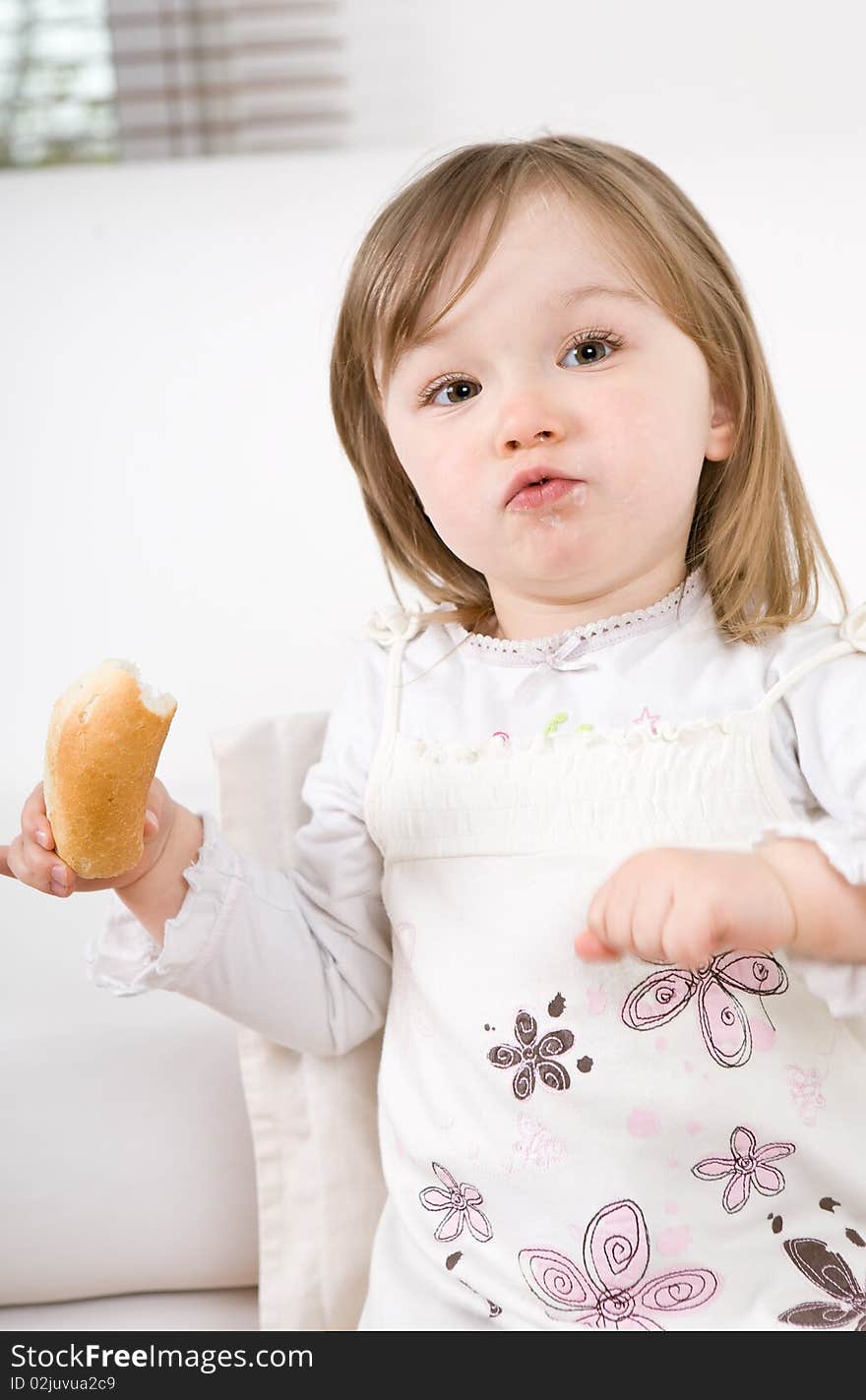 Sweet happy little girl eating