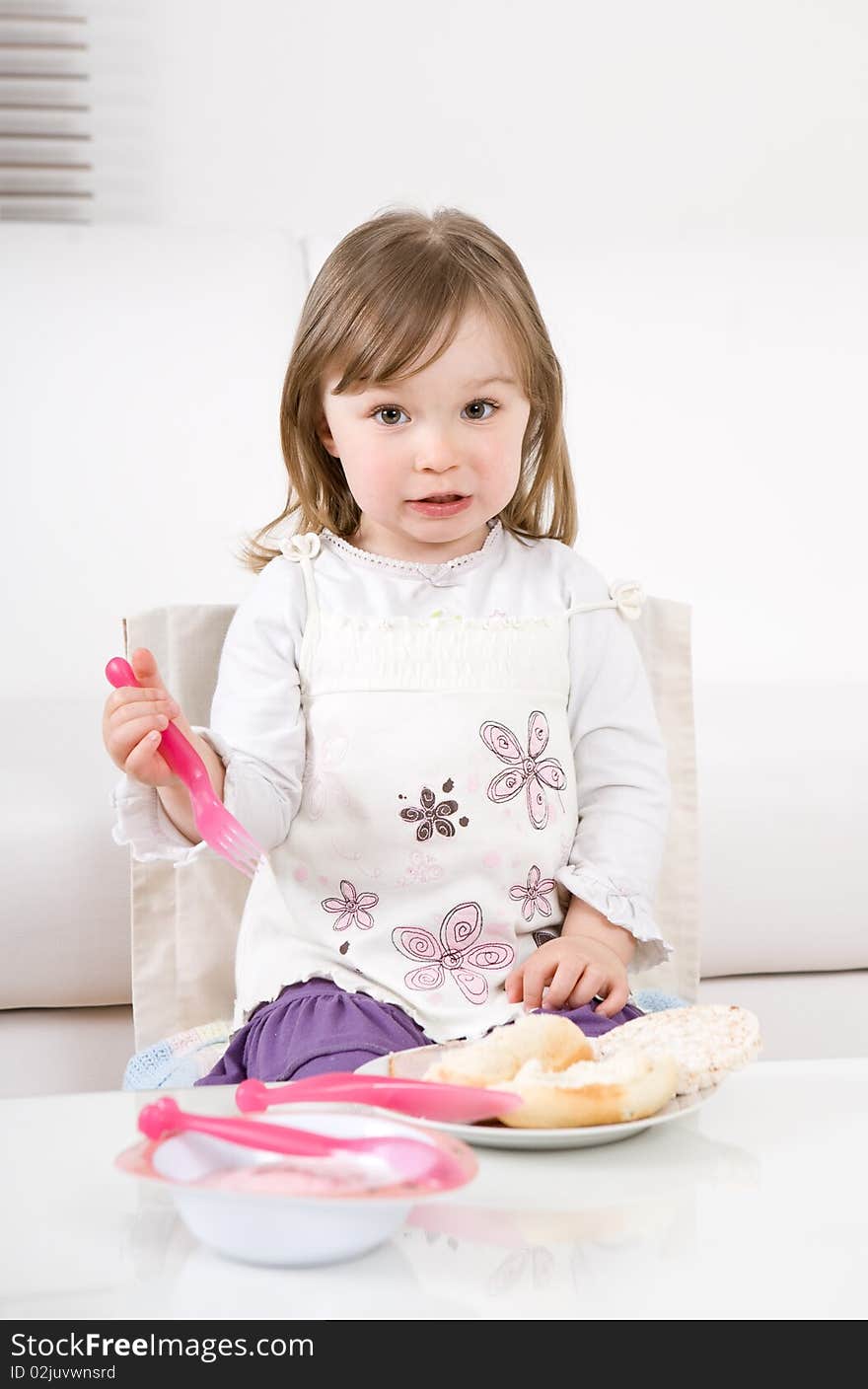 Sweet happy little girl eating