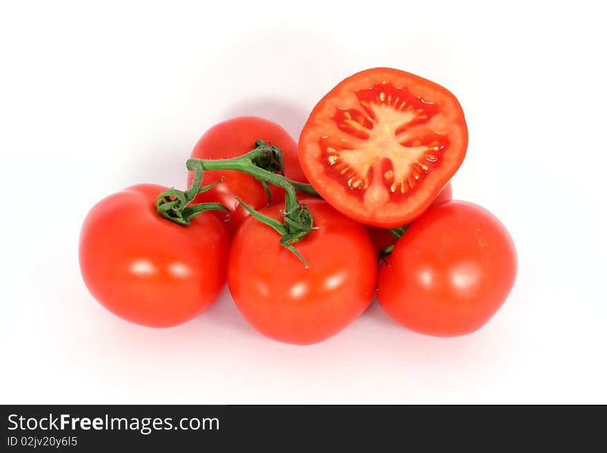 Red tomatoes on the branch isolated on white