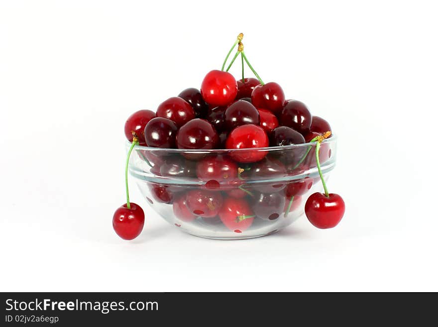 Sweet cherries in a glass bowl isolated on white