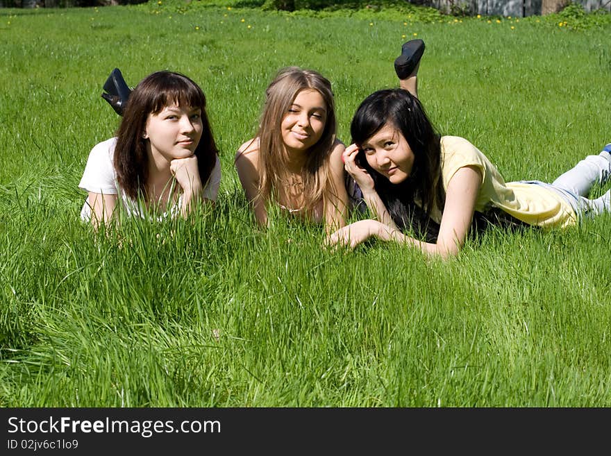 Three girls lying on grass