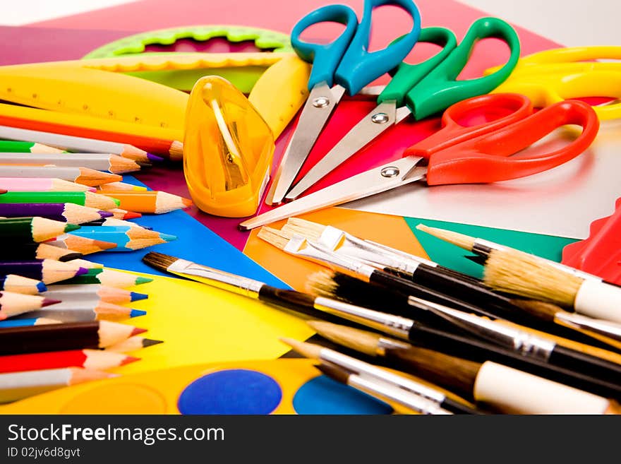 Colorful pencils lying on colorful cardboard sheets. Colorful pencils lying on colorful cardboard sheets