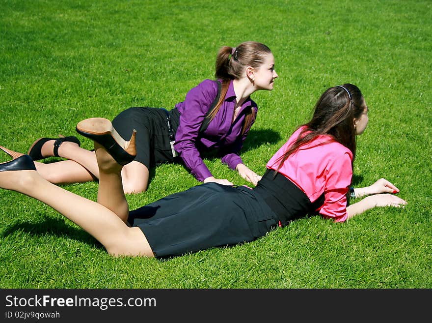 Young businesswomen relaxing on the grass