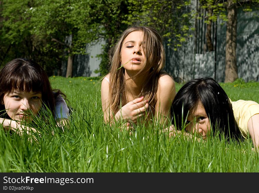 Three girls lying on grass