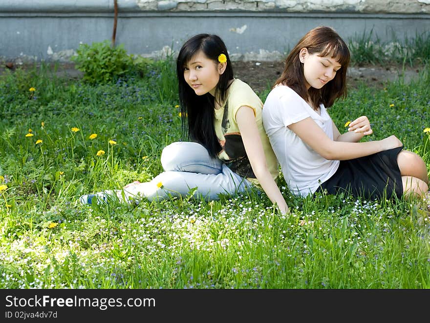 Two girls sitting on grass